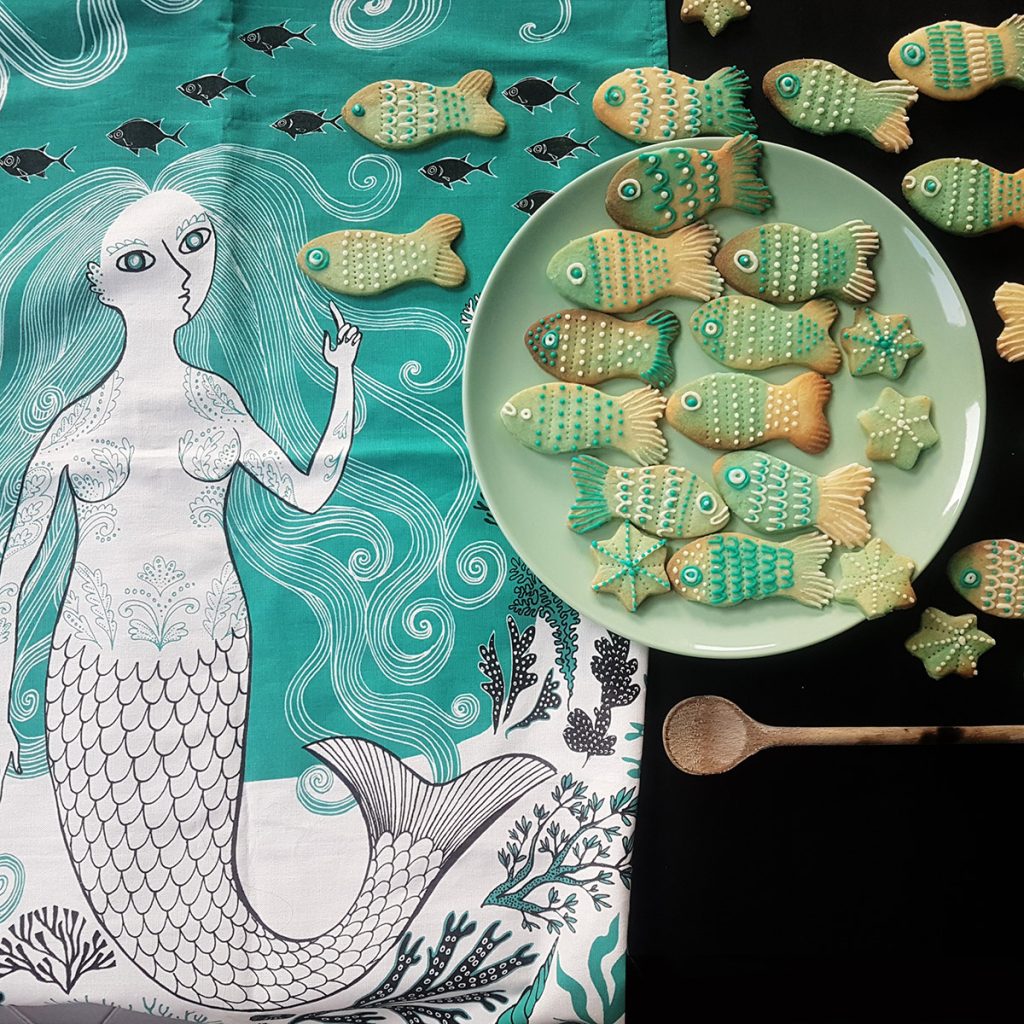 Maria of Lush Designs beautiful fish biscuits swimming past their equally lovely Mermaid tea towel