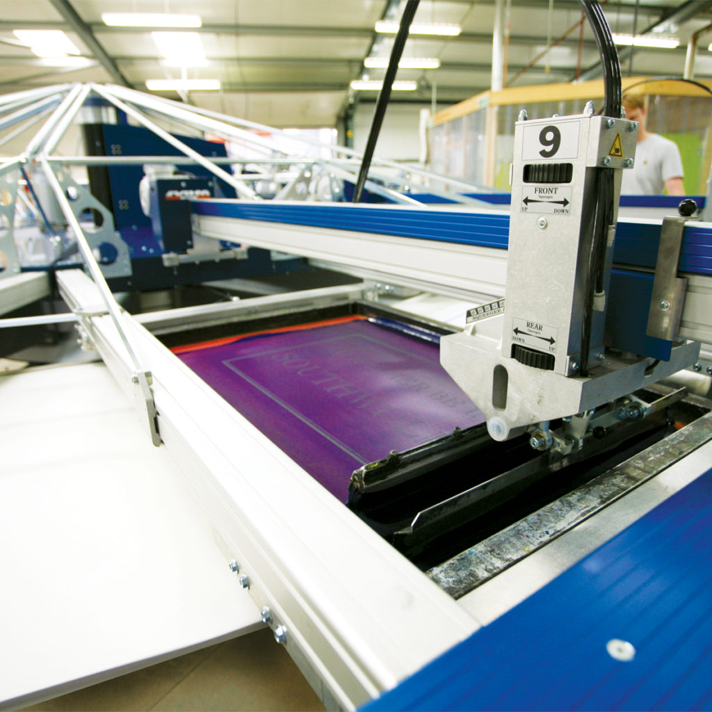 An automatic silk screen print carousel printing tea towels